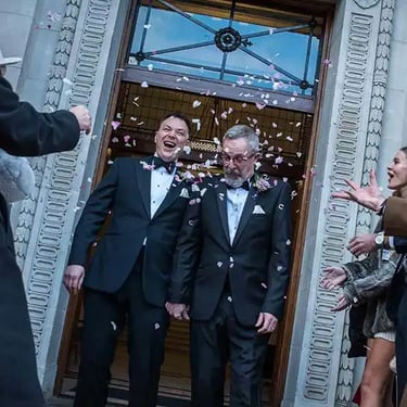 confetti being thrown for wedding couple outisde old marylebone town hall