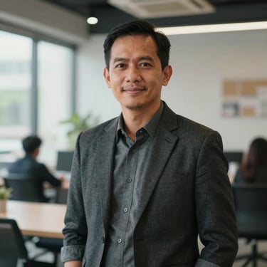 Portrait of a male Indonesian executive in a modern co-working space in Jakarta, looking at the camera with a friendly expression, soft natural lighting.