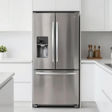 Modern stainless steel French door refrigerator with bottom freezer in a bright white kitchen.