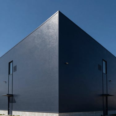 Symmetrical exterior of a modern distribution center, deep navy sky, crisp architectural lines, elegant corporate photography, 35mm