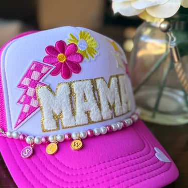 close up of pink mama hat with monogram chain