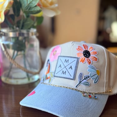 blue and tan mama hat on table 