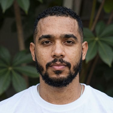 Close-up of hands shuffling tarot cards over a beige cloth with golden accents.