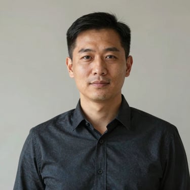 Honest portrait of a real estate broker in a professional dark shirt, neutral background, bright natural daylight.