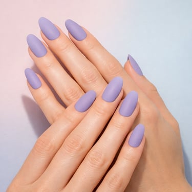 Elegant matte lavender almond nails on a woman's hands over a soft pastel gradient background.