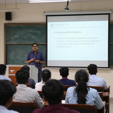 Smiling researcher presenting at an international conference with a laptop.