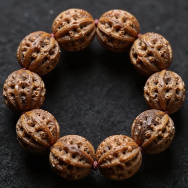 Symmetrical close-up of a rare fourteen-mukhi Rudraksha bead, intricate geometric crevices, dark atmospheric lighting