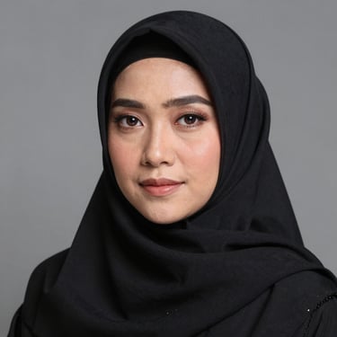 A joyful middle-aged Indonesian woman in a white hijab smiling during her Umrah trip.