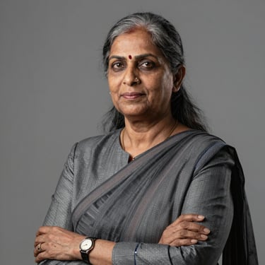 Formal professional portrait of a senior Indian female legal director in professional attire, confident and dignified, neutral studio background.