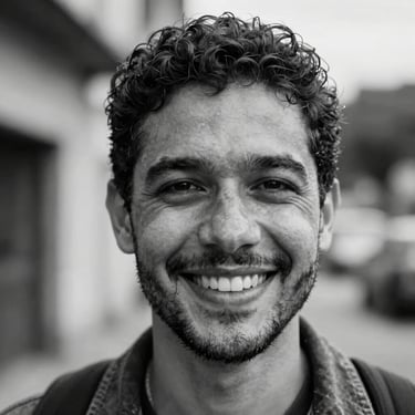 Close-up portrait of Wagner Rodrigues Wagão, professional journalist and cultural producer, smiling, warm natural light, black and white.