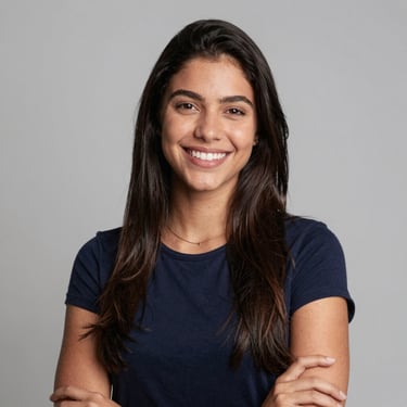 Smiling young woman showing her aligned teeth in a bright, modern orthodontic clinic.