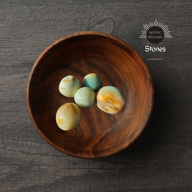 caribbean calcite stones in a handcrafted wooden bowl for meditation.