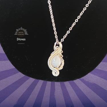 Handmade wire wrapped moonstone pendant necklace on a silver chain for crystal healing jewelry.