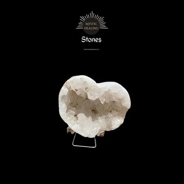 Heart-shaped white quartz geode crystal on a metal stand for mystic healing and home decor.