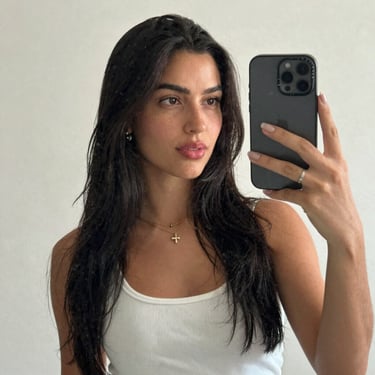 A cheerful child happily coloring with crayons at a bright, colorful table.