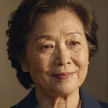 A warm, close-up portrait of an elderly sister with a peaceful expression, soft lighting, elegant Caslon feel.