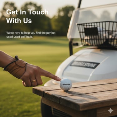 A hand pointing to a Bridgestone used golf ball on a wooden table near a golf cart on a green course.