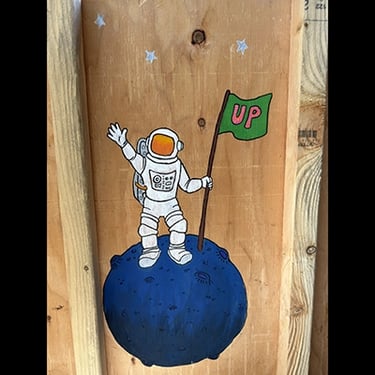 Shipping crate for Talbotics sculpture with image of astronaut drawn on it.
