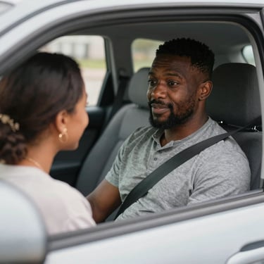 A cheerful young man sitting at a desk using a laptop to book a health screening appointment.