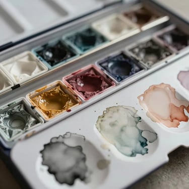 Close up of watercolor mixing palette with muted earth tones, soft diffused light