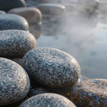 Close-up of smooth granite stones next to a steaming natural hot spring, soft morning mist, macro photography, square crop