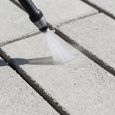 Extreme close-up of the same concrete paving slabs after high-pressure cleaning, bright natural daylight revealing clean pale grey surface with sharp texture detail, no people