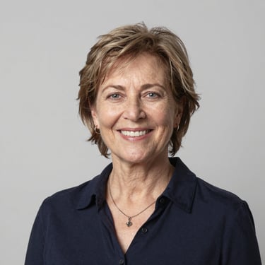 A serene woman sitting peacefully in a sunlit room, eyes closed, embracing calm.