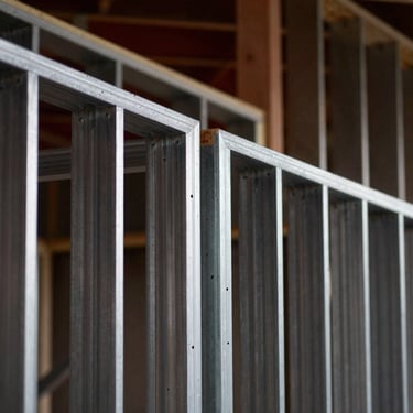 Extreme close-up of perfectly aligned metal framing studs in a modern residential build, sharp focus, dramatic lighting