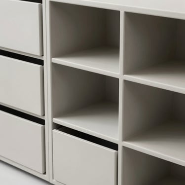 Minimalist modular storage containers made of matte polymers, clean lines, high-contrast studio lighting