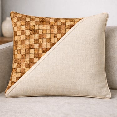 Modern decorative throw pillow with a dual-texture design of cork mosaic and cream linen fabric.
