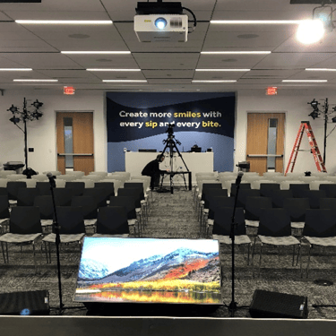 Conference room staged with seating, staging, and AV ahead of an enterprise event in Plano Texas.
