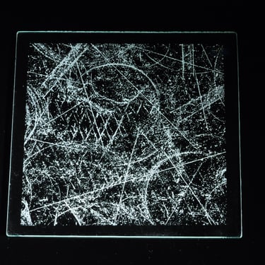 Abstract glass etching against black background