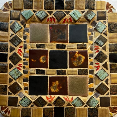 Mosaic ceramic tile in natural brown, tan, and orange pieces