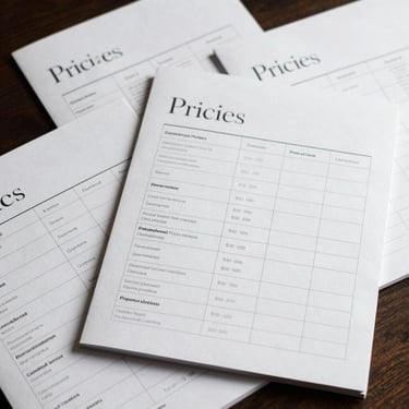 A digital flat-lay of a multi-page pricing guide template with structured grids and elegant editorial serif headers.