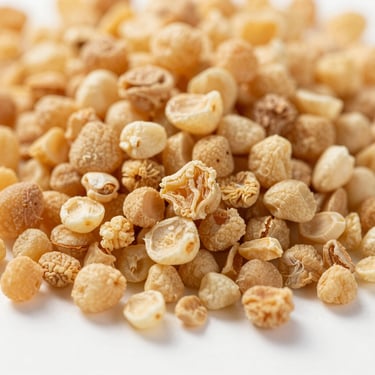 Macro shot of dehydrated garlic granules, warm golden hue, clean studio lighting.