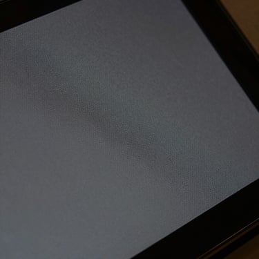 Extreme close-up of anti-glare matte film on a digital screen, satin texture, zero fingerprints.