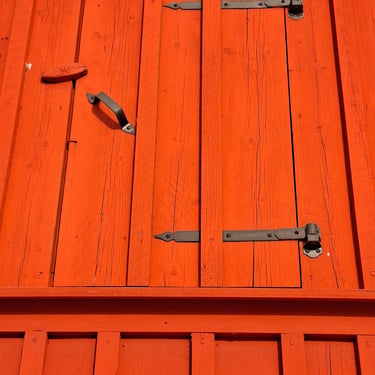 Historic board and batten wood siding with an exterior staircase on a traditional farmhouse.