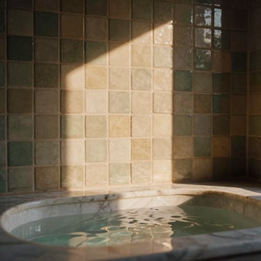 Tactile zellige tiles in soft olive and sand tones, water gently rippling in a marble basin, soft side lighting, medium format film.