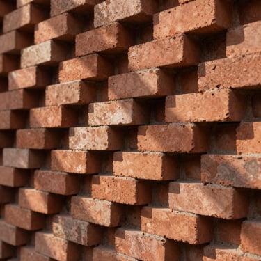 Tactile architectural detail of stacked terracotta bricks under soft natural afternoon light, shadows creating geometric patterns, close-up.