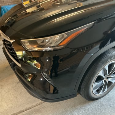 A black Toyota front bumper and LED headlight after scratch repair with Lev Auto Refinishing.