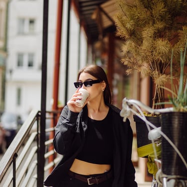 Mujer viste elegante suéter negro, top, jeans y cinturón moda internacional México