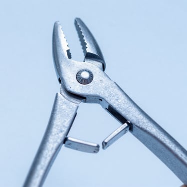 Macro close-up of heavy-duty orthopedic bone rongeur jaws, cool blue clinical lighting, sharp focus on the stainless steel texture.