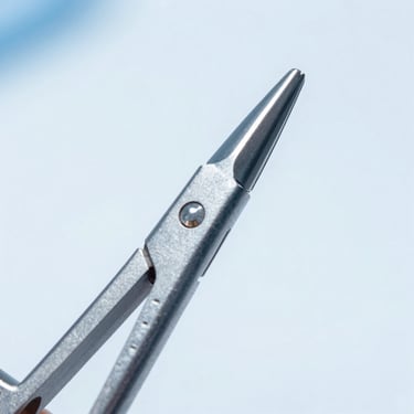 Macro close-up of a stainless steel surgical clamp tip, bright clinical lighting, sterile white background, razor-sharp alignment details.