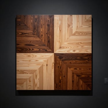 An abstract veneer painting featuring geometric lines of dark oak and figured maple, spotlighted on a dark gallery wall
