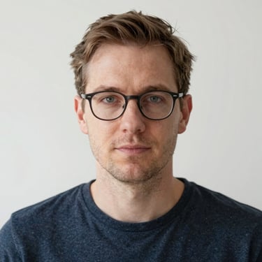 Man reviewing website designs on a tablet with a focused expression.