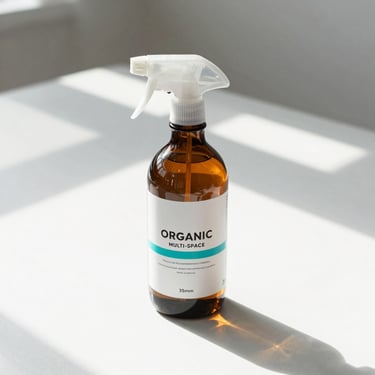 Sleek amber glass bottle of organic multi-surface cleaner, sunlit clean tabletop, architectural shadows