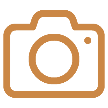 A brown DSLR camera line icon representing photography, media, or digital imaging.