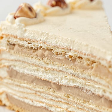 Extreme close-up of a layered chocolate hazelnut cake, delicate crumb, soft morning light