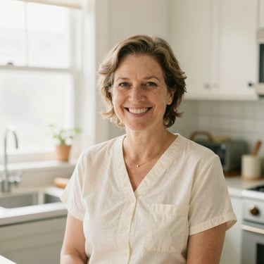 Warm lifestyle portrait of Mindy, an experienced caregiver, smiling in a sunlit home kitchen, soft natural light, 35mm