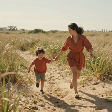 A mother and child running through a sun-drenched field of tall grass, warm sand tones, candid interaction